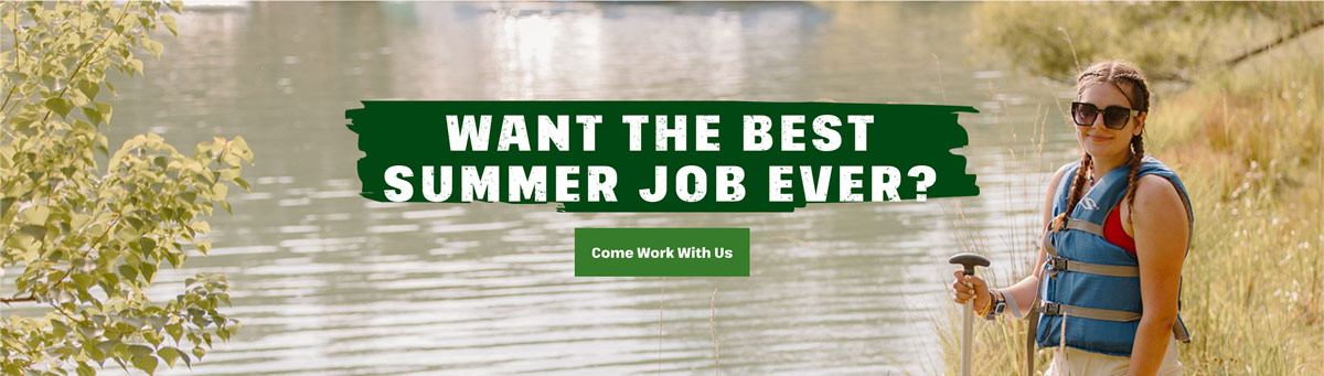 Person in a life jacket stands by a lake holding a paddle. Text reads: "Want the best summer job ever? Come work with us.